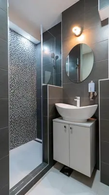 a bathroom with a sink and a shower with a mirror at Burgundy Apartment in Belgrade