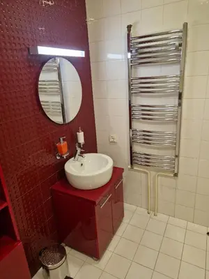 a bathroom with a sink and a mirror at STATUS Superior Apartments in Belgrade