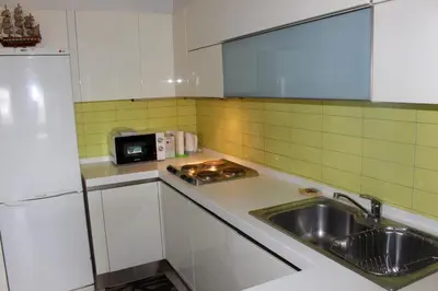 a small kitchen with a sink and a microwave at STATUS Superior Apartments in Belgrade