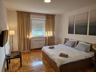 a bedroom with a bed with two books on it at STATUS Superior Apartments in Belgrade