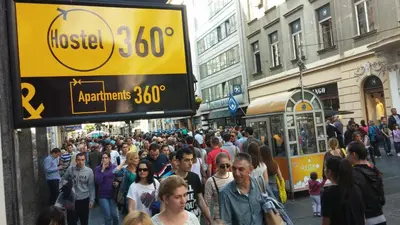 a crowd of people walking down a busy city street at Hostel Bed&Coffee 360° in Belgrade