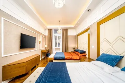 a hotel room with two beds and a television at Royal Knez in Belgrade