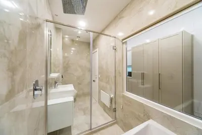 a bathroom with a shower and a sink and a mirror at Royal Knez in Belgrade