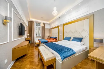 a bedroom with a large bed with blue pillows at Royal Knez in Belgrade