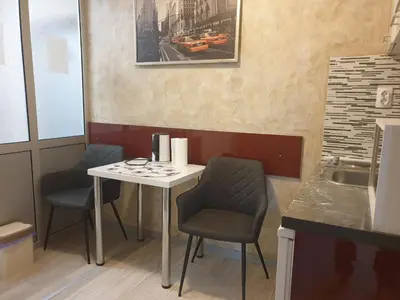 a small table and two chairs in a restaurant at Guest House Boska in Pančevo
