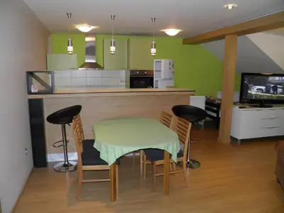 a kitchen with a table and chairs and a counter at Guest House Boska in Pančevo