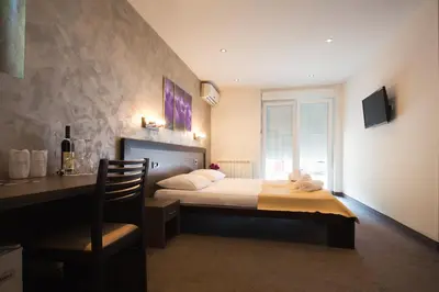a bedroom with a bed and a desk with a chair at Villa Mystique in Belgrade