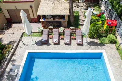 an overhead view of a swimming pool with chairs and umbrellas at Villa Mystique in Belgrade