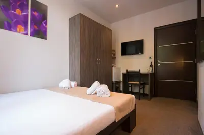 a bedroom with a bed with towels on it at Villa Mystique in Belgrade