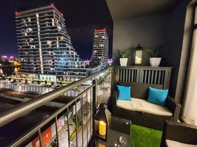 a balcony with a view of a city at night at Belgrade Waterfront - Beograd na vodi in Belgrade