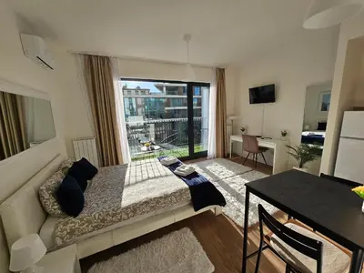 a bedroom with a bed and a large window at Belgrade Waterfront - Beograd na vodi in Belgrade