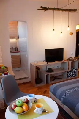 a living room with a table with a bowl of fruit on it at BGMignonne, so cozy, so relaxing, so near center in Belgrade