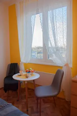 a table and chairs in a room with a window at BGMignonne, so cozy, so relaxing, so near center in Belgrade