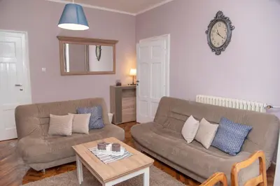 a living room with a couch and a table at Sweet House Trg in Belgrade