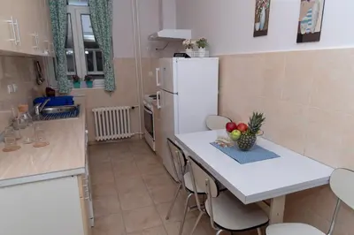 a kitchen with a counter and a white refrigerator at Sweet House Trg in Belgrade