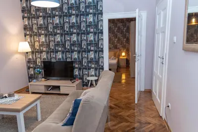 a living room with a couch and a tv at Sweet House Trg in Belgrade