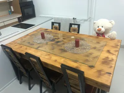 a teddy bear sitting on top of a wooden table at Apartment on a river avenue in Pančevo