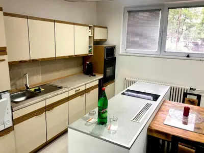 a small kitchen with a bottle on a table at Apartment on a river avenue in Pančevo