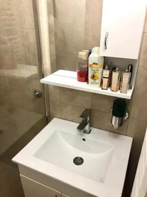 a bathroom with a white sink and a shower at Apartment on a river avenue in Pančevo
