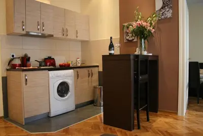 a kitchen with a washing machine and a washer at Belgrade Stay Apartments in Belgrade