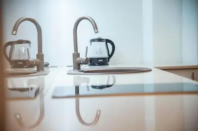 a kitchen counter with two coffee makers on it at Drop In Apartments in Belgrade