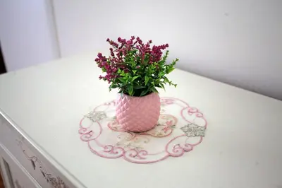 a pink vase filled with purple flowers on a table at City Center Belgrade Queen Apartment Skadarlija in Belgrade