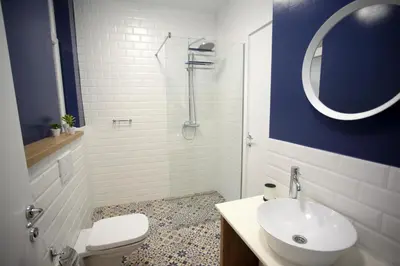a bathroom with a sink and a toilet and a mirror at City Center Belgrade Queen Apartment Skadarlija in Belgrade