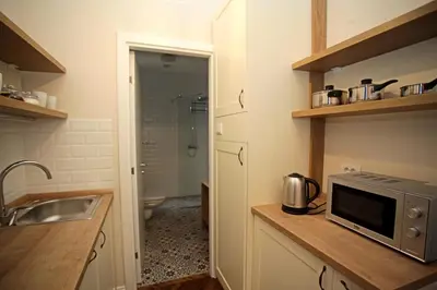 a kitchen with a sink and a microwave on a counter at City Center Belgrade Queen Apartment Skadarlija in Belgrade
