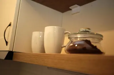 a shelf with two cups and a jar on it at City Center Belgrade Queen Apartment Skadarlija in Belgrade