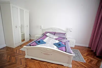 a bedroom with a bed with purple and purple sheets at City Center Belgrade Queen Apartment Skadarlija in Belgrade