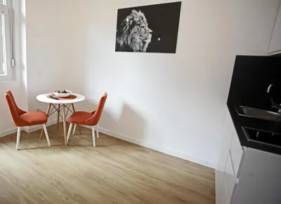 a white room with a table and two chairs at City Center Belgrade Cozy Apartment Skadarlija in Belgrade