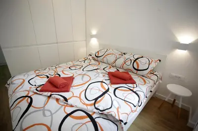 a bedroom with a bed with two red pillows at City Center Belgrade Cozy Apartment Skadarlija in Belgrade