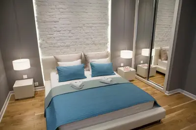a bedroom with a large bed and a mirror at Supreme Palace Cube in Belgrade