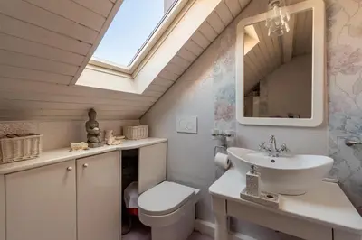 a bathroom with a sink toilet and a skylight at KLARA VRACAR 90 m2, dve i po spavace sobe in Belgrade