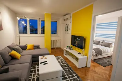 a living room with a couch and a tv at Tamy lux apartment in Belgrade
