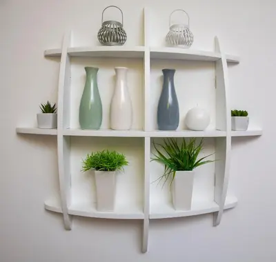 a shelf with vases and plants on a wall at Tamy lux apartment in Belgrade