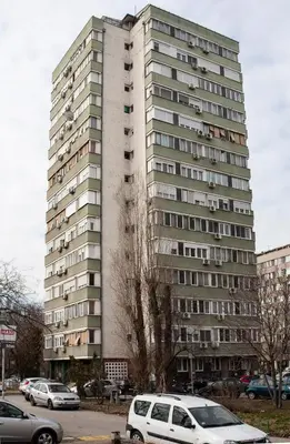 a tall building with cars parked in front of it at Tamy lux apartment in Belgrade