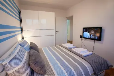 a bedroom with a bed and a flat screen tv at Tamy lux apartment in Belgrade