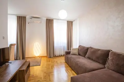 a living room with a couch and a television at Thomas Residence in Belgrade