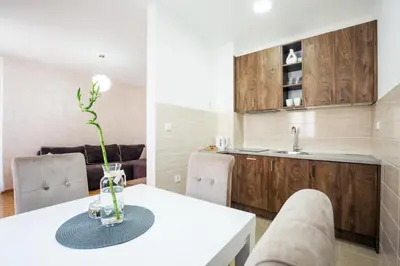 a kitchen with a white table with a vase on it at Thomas Residence in Belgrade