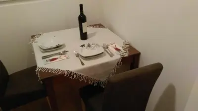 a table with a bottle of wine and a wine glass at White Pearl in Belgrade