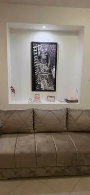 a couch in a room with a picture on the wall at White Pearl in Belgrade