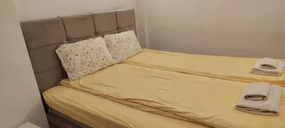 a bed with two towels and two pillows on it at White Pearl in Belgrade