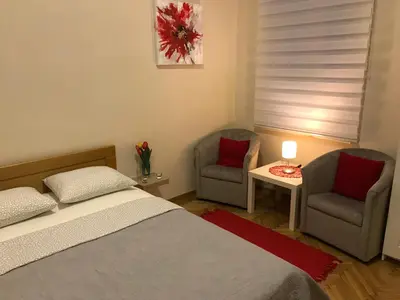 a bedroom with two chairs and a bed and a table at Belgrade 1911 apartment in Belgrade