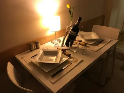 a table with a bottle of wine and a glass at Belgrade 1911 apartment in Belgrade