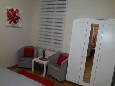 a bedroom with two chairs and a mirror at Belgrade 1911 apartment in Belgrade
