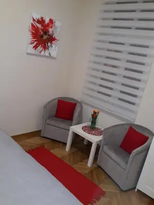 a room with two chairs and a table and a bed at Belgrade 1911 apartment in Belgrade