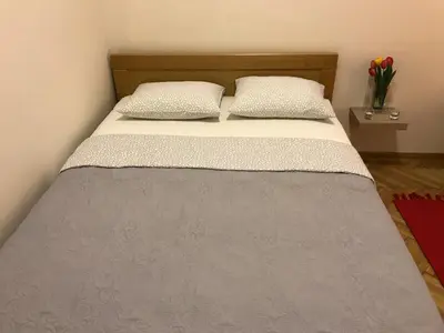 a bed with two pillows on it in a room at Belgrade 1911 apartment in Belgrade