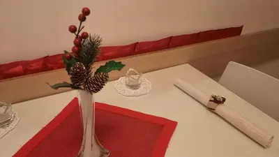 a table with a vase with christmas decorations on it at Belgrade 1911 apartment in Belgrade