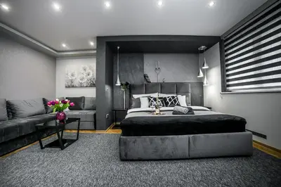 a bedroom with a large bed and a couch at Sinergija in Belgrade